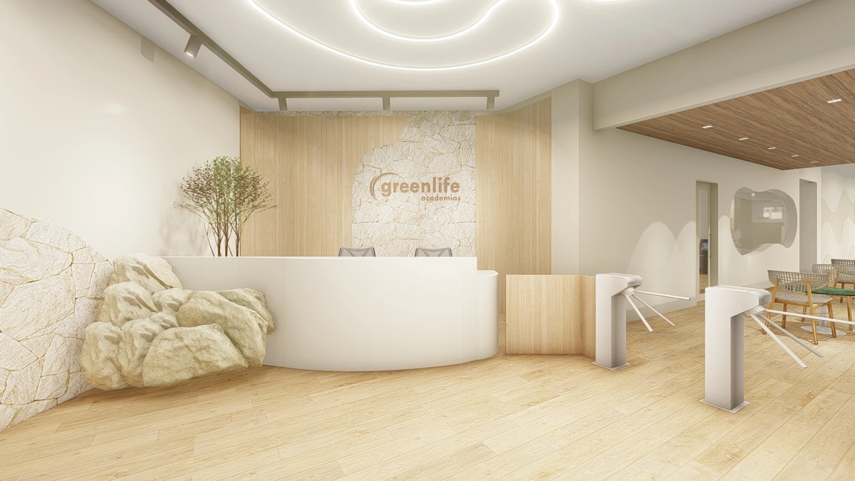 Recepção da academia Greenlife, com balcão branco, parede de pedra e o logo da marca
